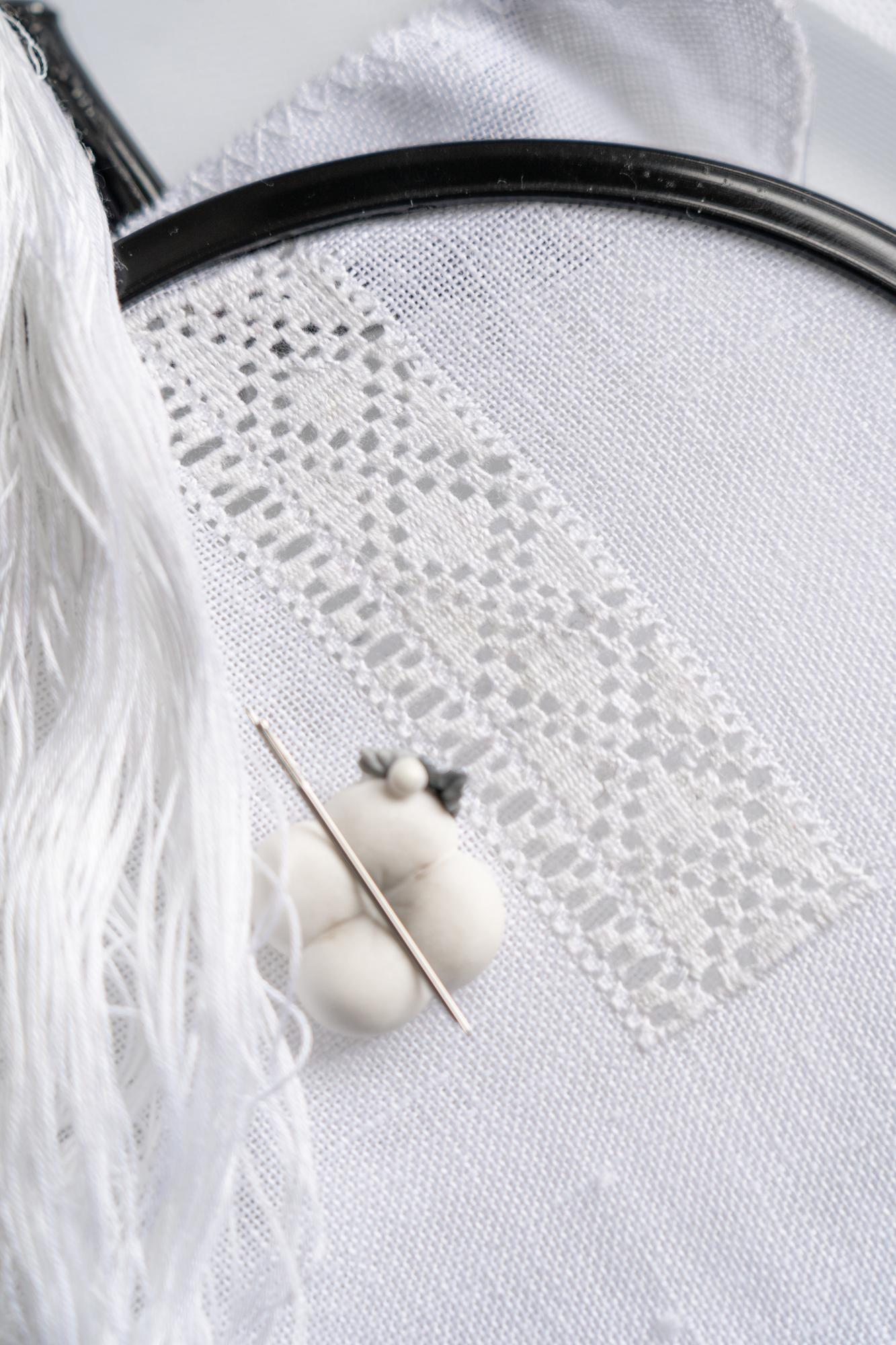 Monogramm auf Leinentuch mit feinen Stichen
